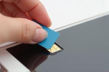 Close up of a SIM card being inserted into a phone